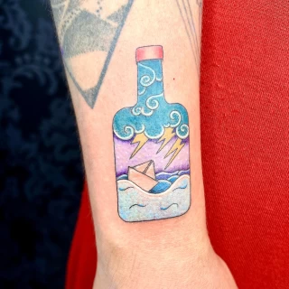 Barbara - resident artist - flash tattoo- boat in a bottle - innocent style - color work - the black hat tattoo Nice - 2025 - The Black Hat Tattoo